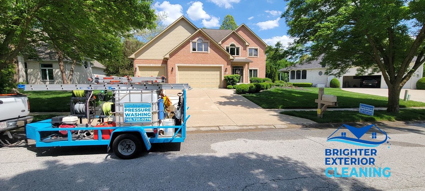 A blue truck is parked in front of a large brick house.