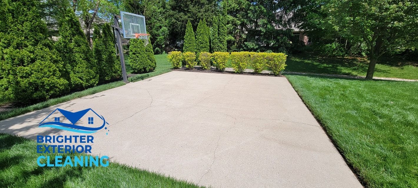 There is a basketball hoop in the backyard of a house.