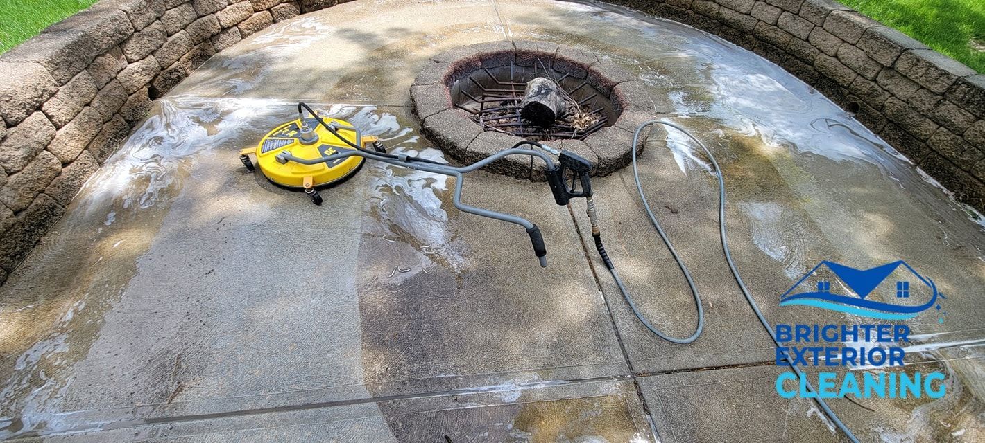 A fire pit is being cleaned with a pressure washer.