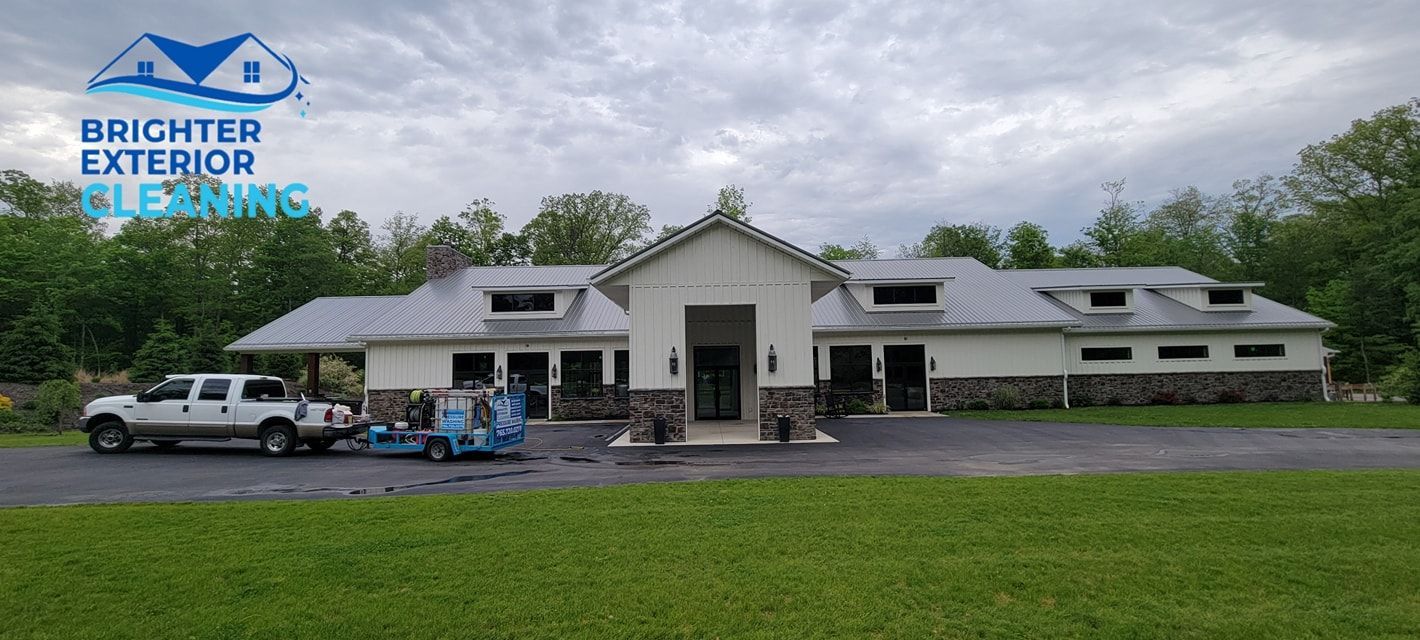 A large white house with a truck parked in front of it.