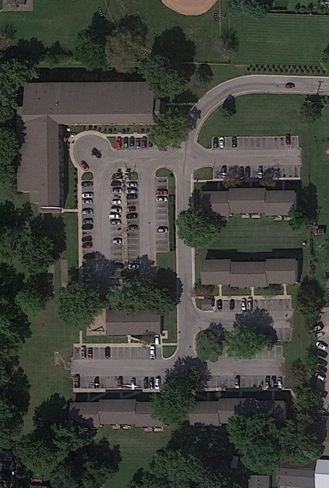 An aerial view of a residential area with lots of parking spaces