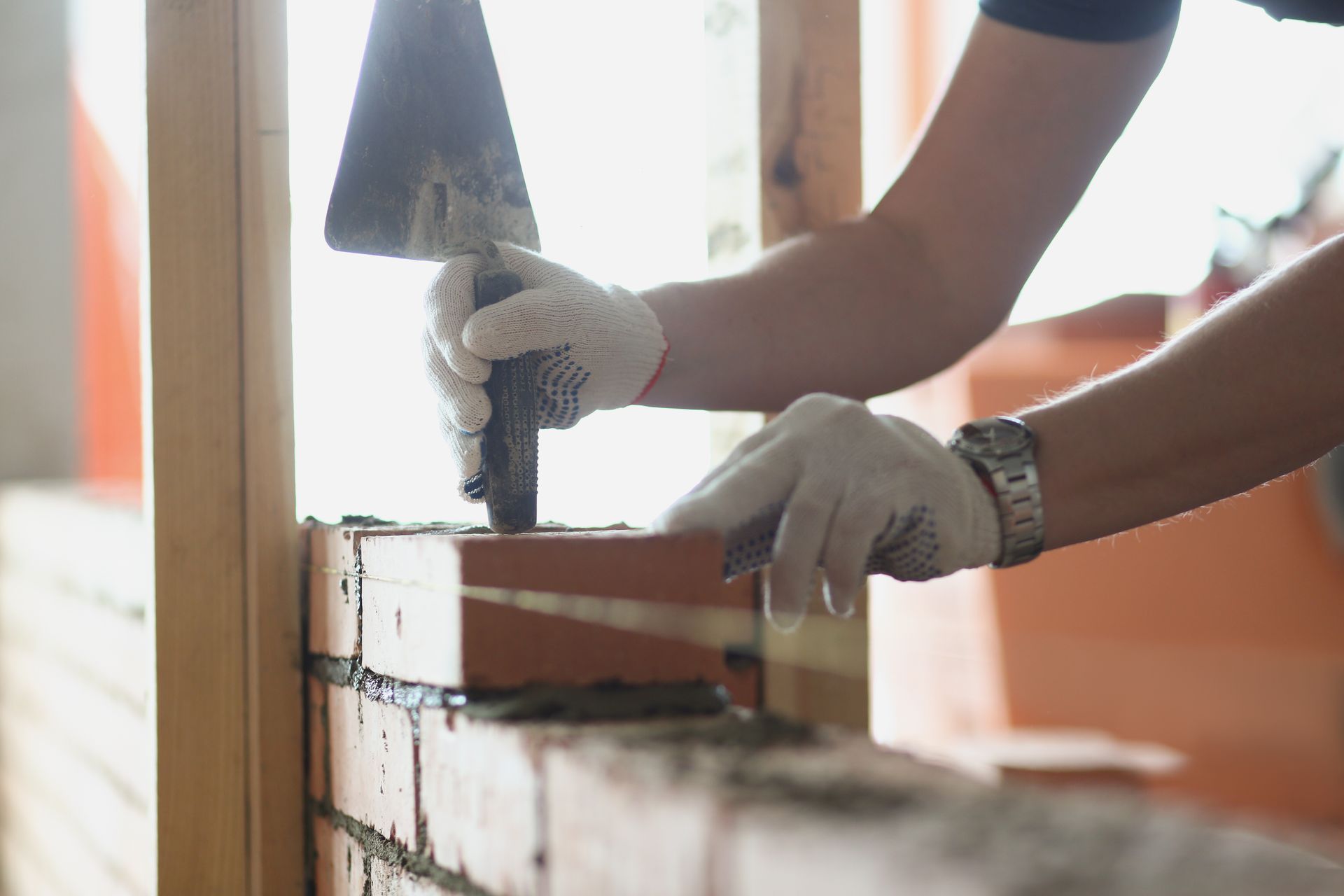 Expert mason laying bricks with a trowel for high-quality professional masonry repair services.