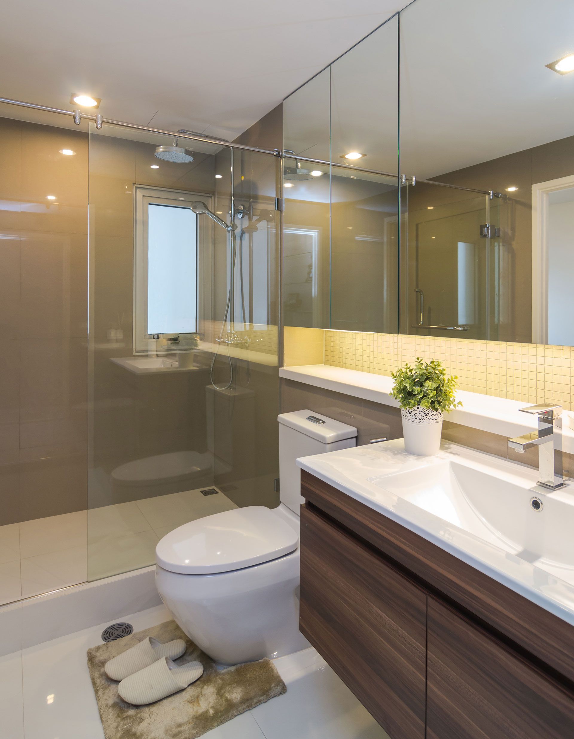 A bathroom with a toilet , sink , and shower.
