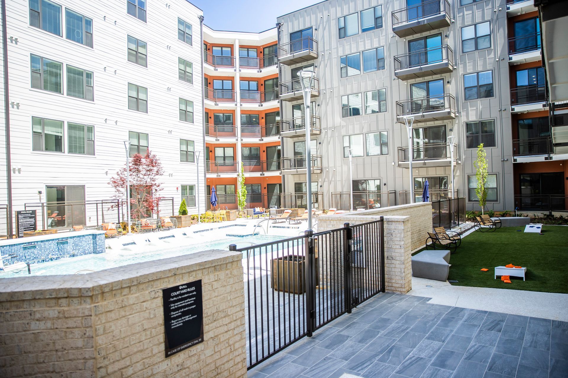 a large apartment building with a swimming pool in the middle of it .