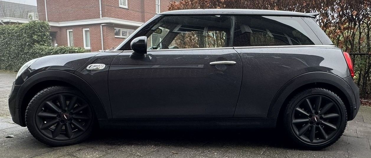 Donkergrijze Mini Cooper met chrome raamlijsten 