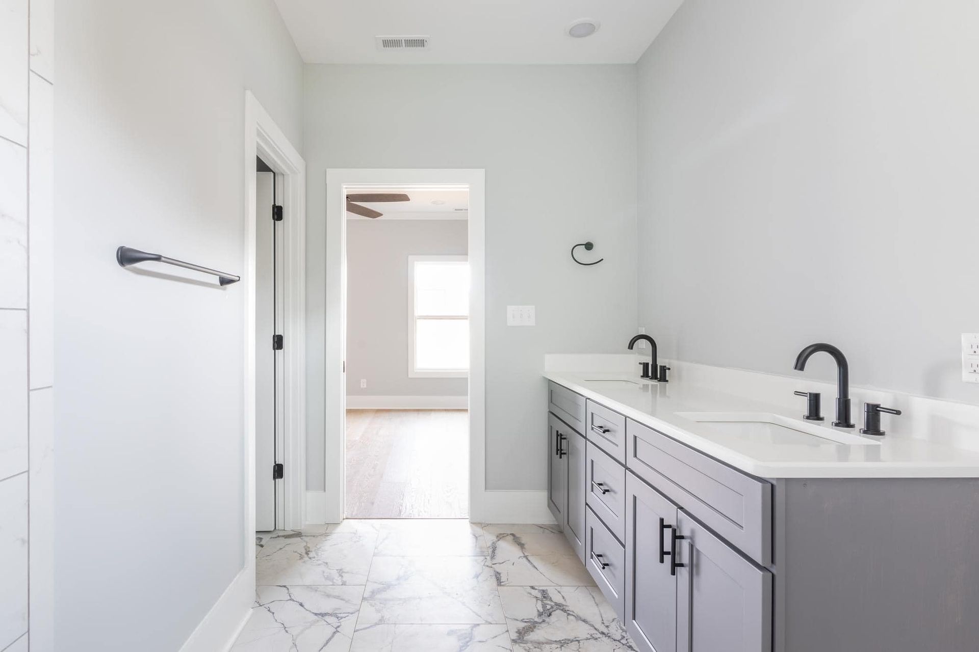 A bathroom with two sinks and a marble floor.