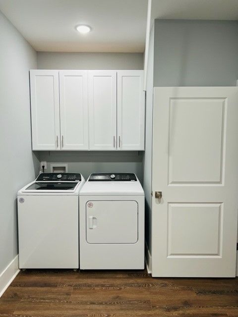 A laundry room with a washer and dryer and a door.
