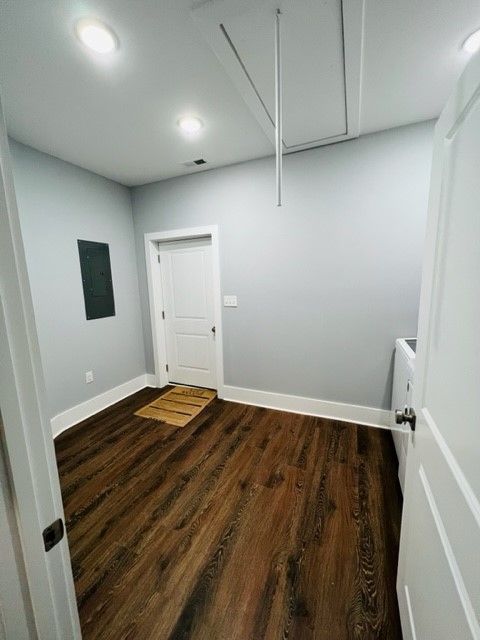 A room with hardwood floors and gray walls.