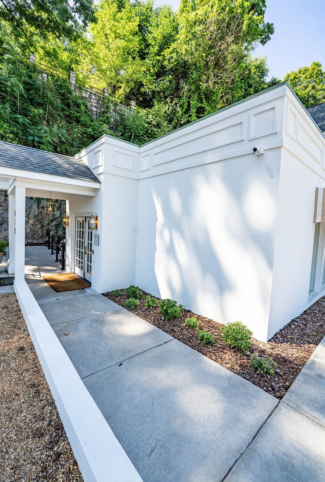 A white house with a walkway leading to it