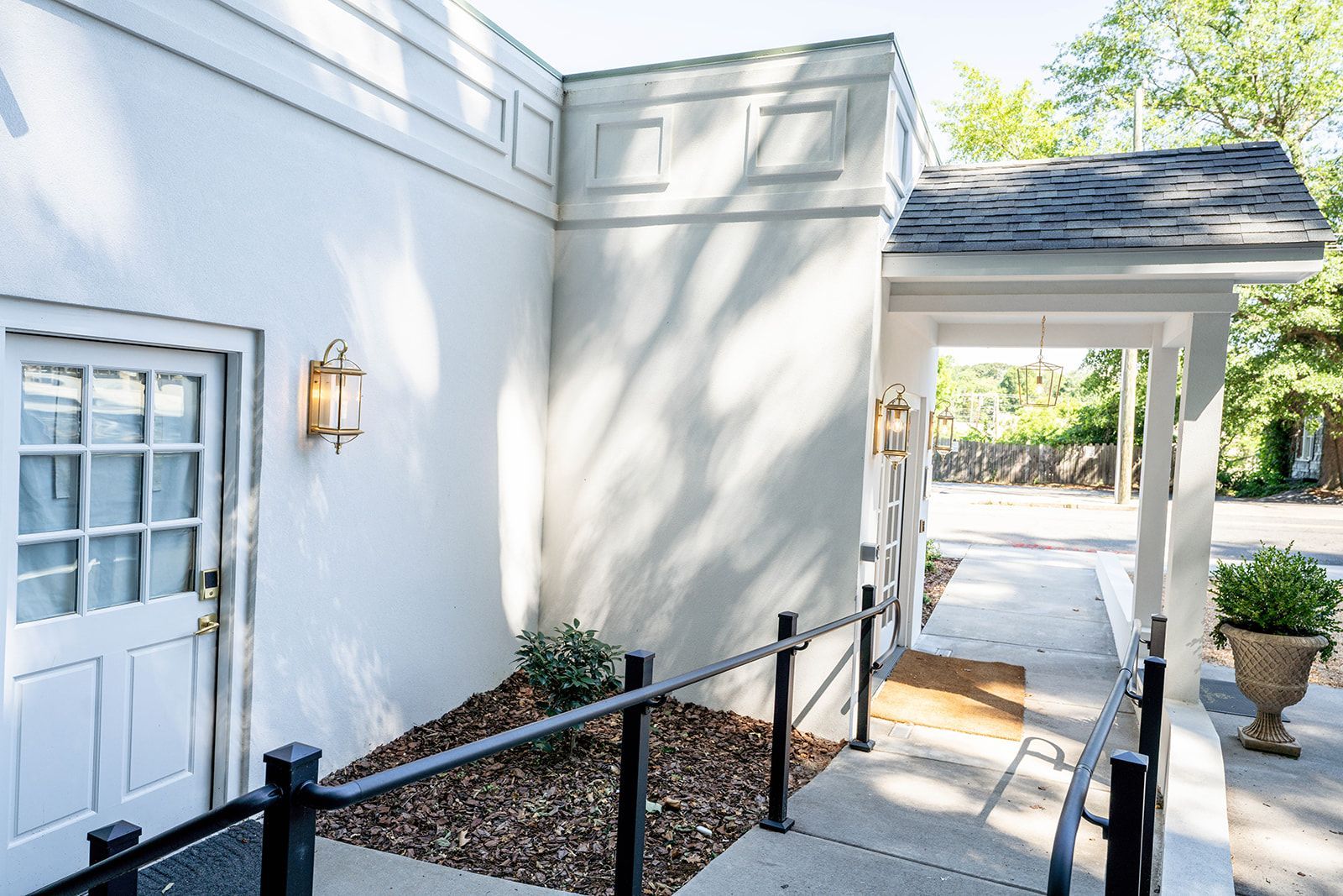 A white house with a ramp leading to the door.
