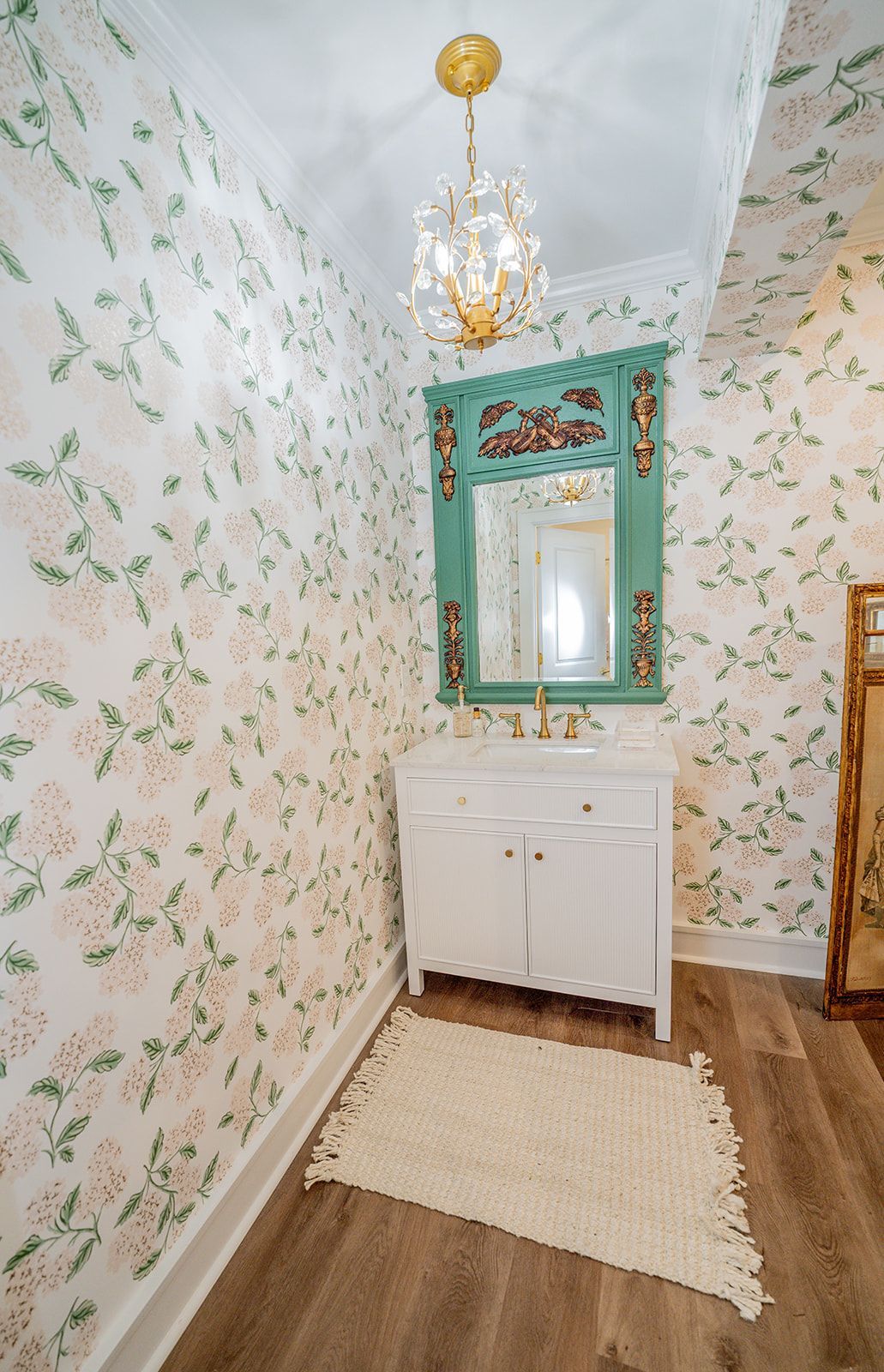 A bathroom with a sink , mirror , and rug.