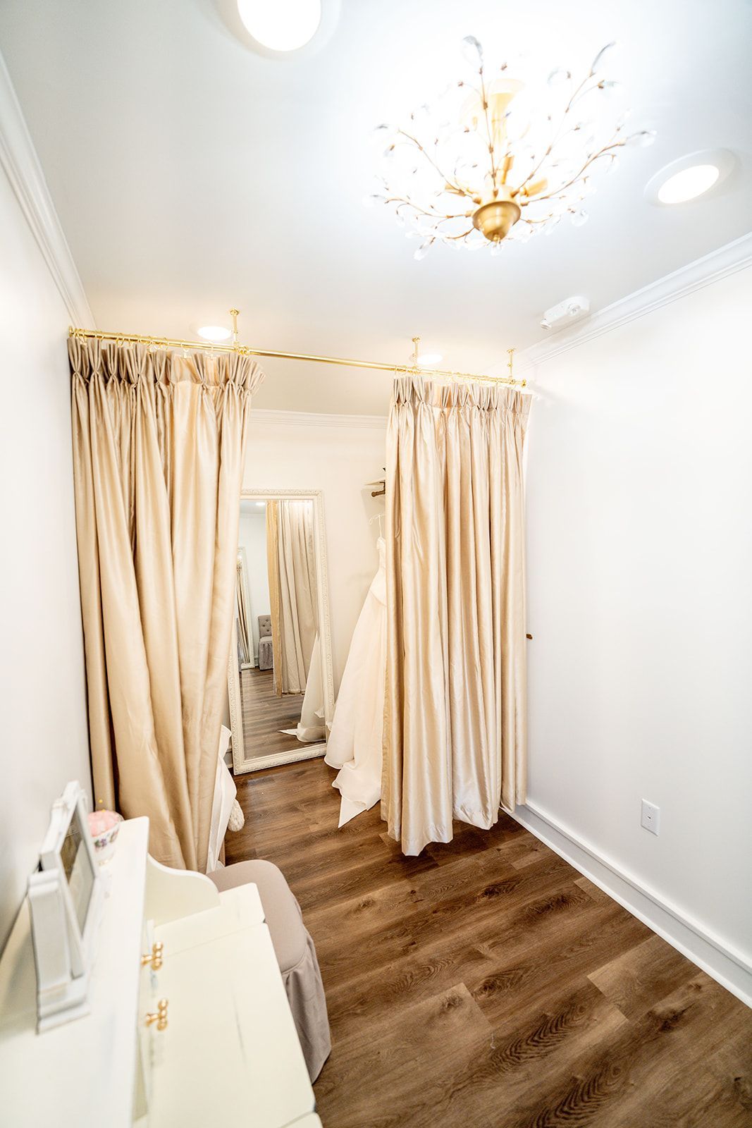 A dressing room with curtains and a mirror.