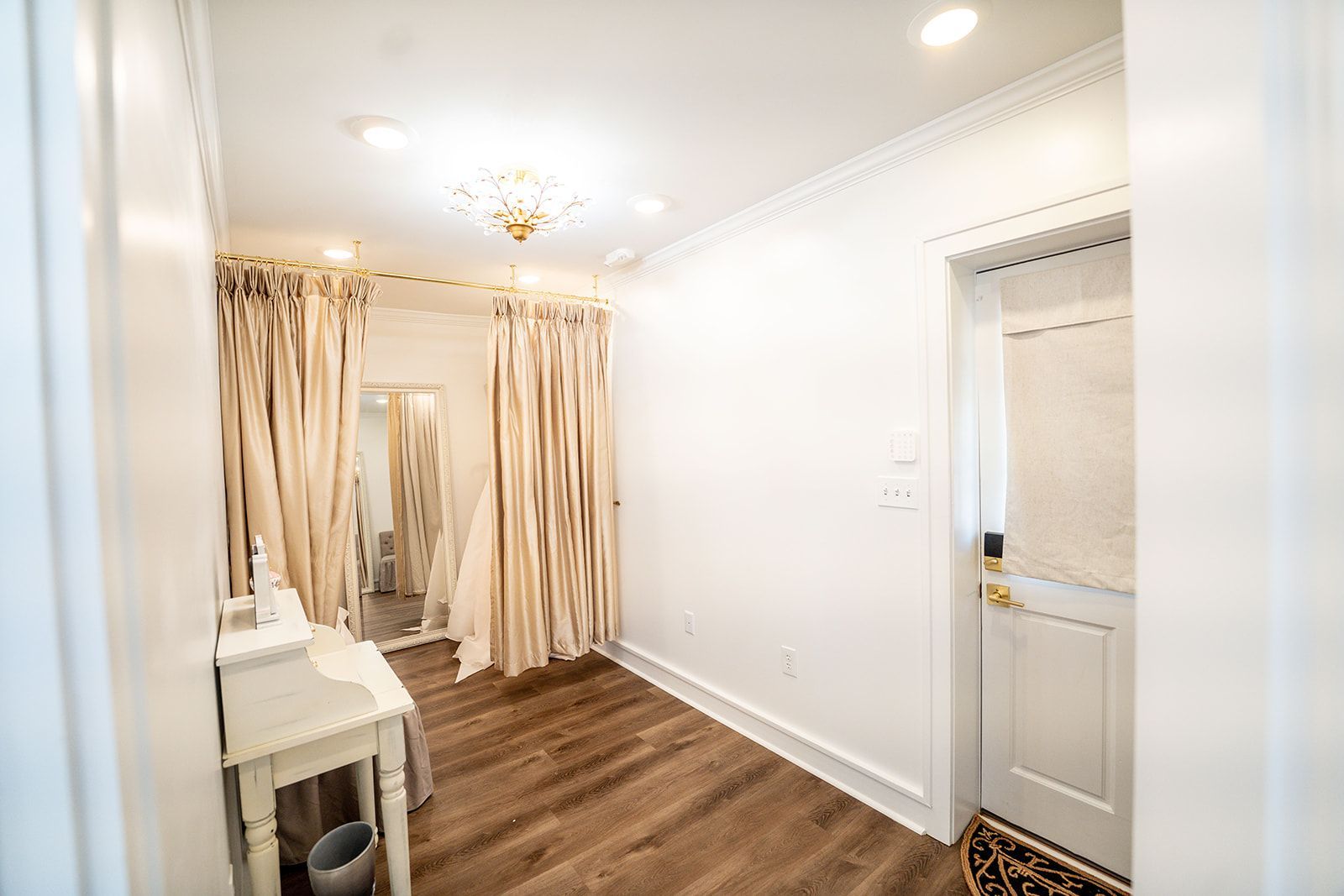 It is a dressing room with a mirror and curtains.