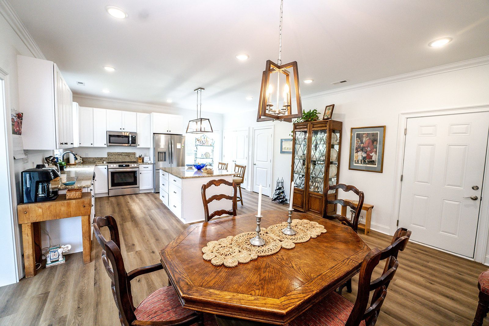 A kitchen and dining room in a house with a wooden table and chairs.
