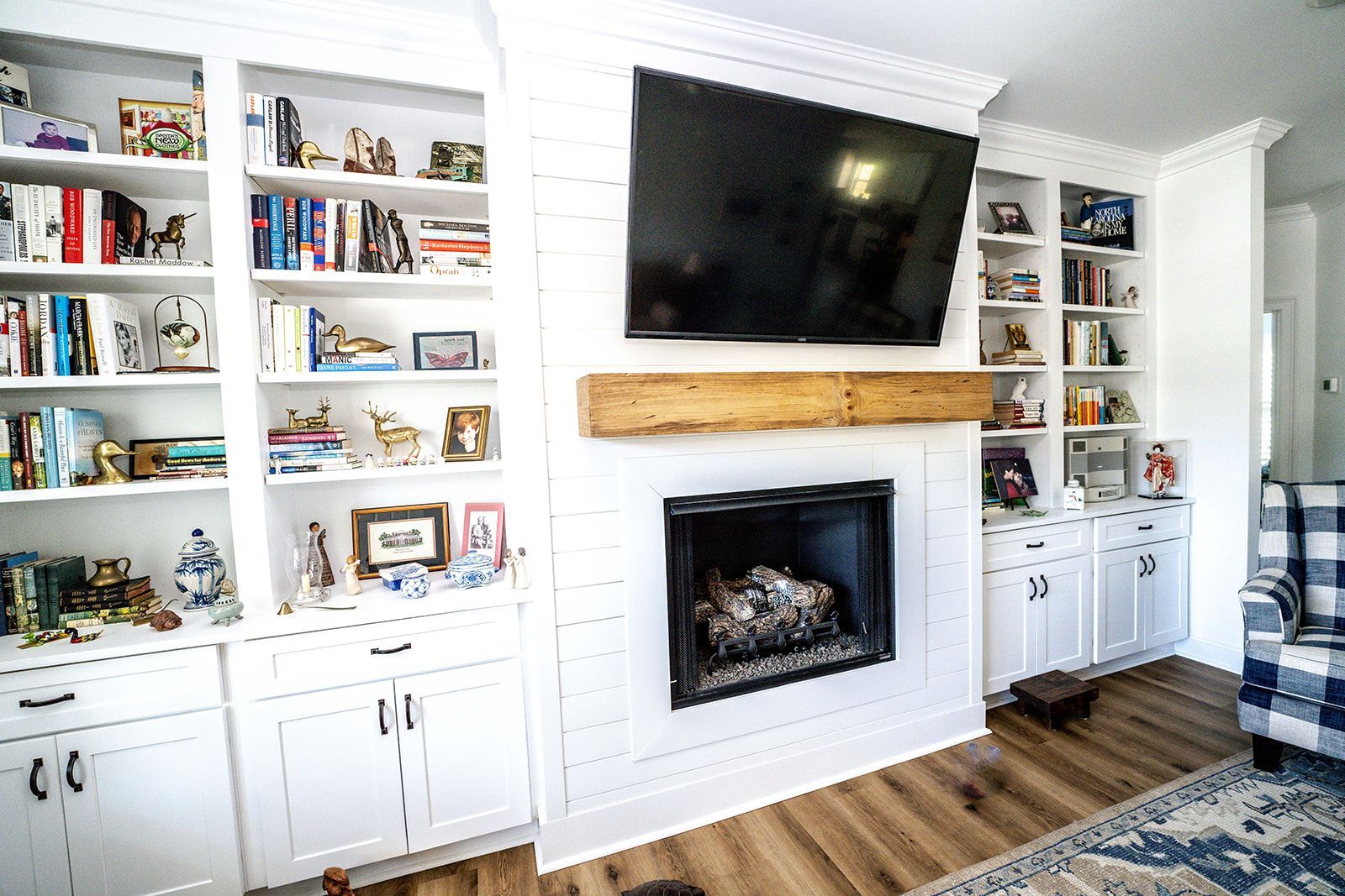 A living room with a fireplace and a flat screen tv.