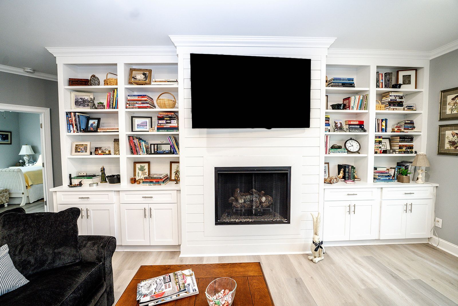 A living room with a fireplace and a flat screen tv.