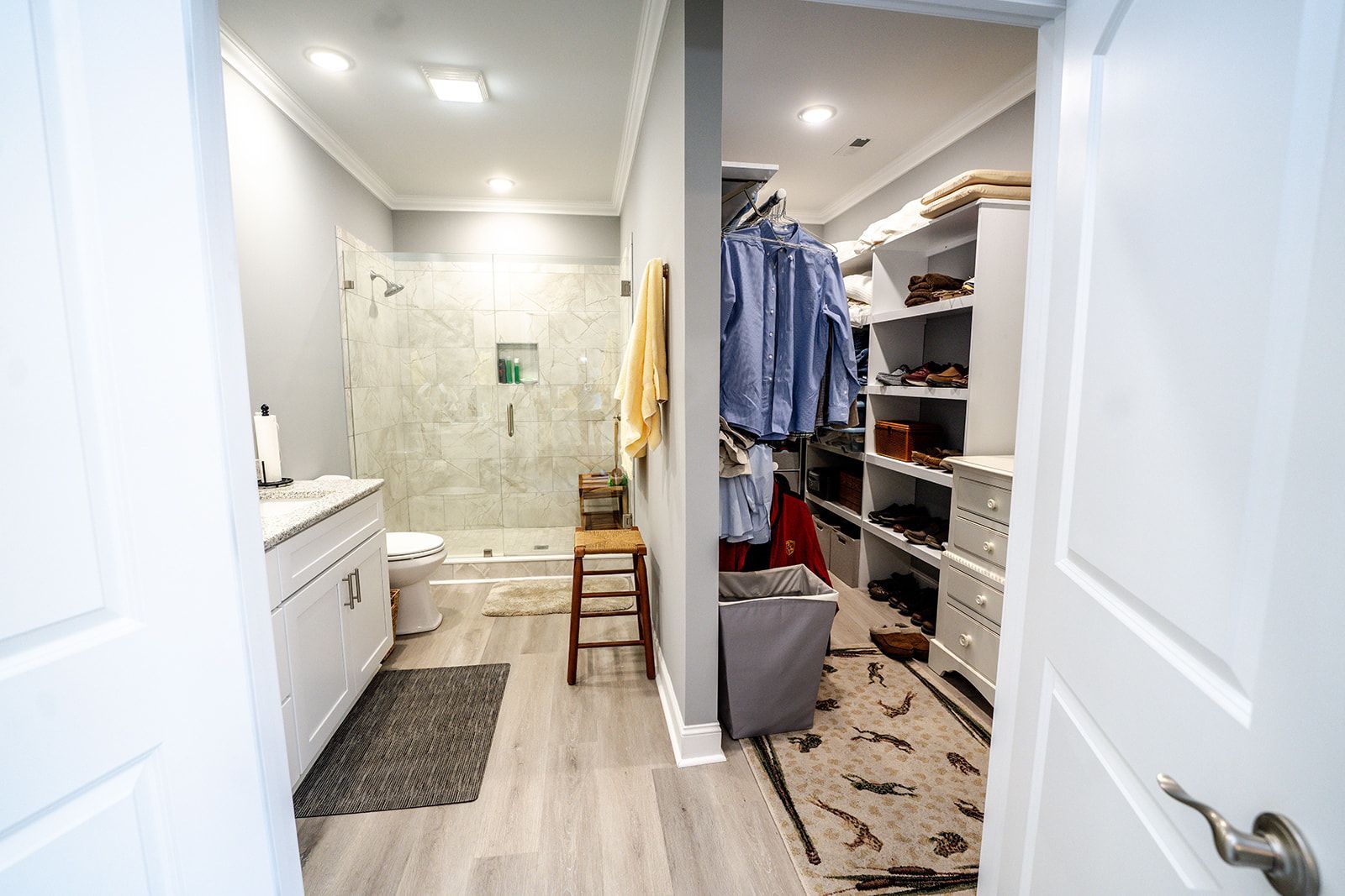 A bathroom with a walk in closet and a toilet.