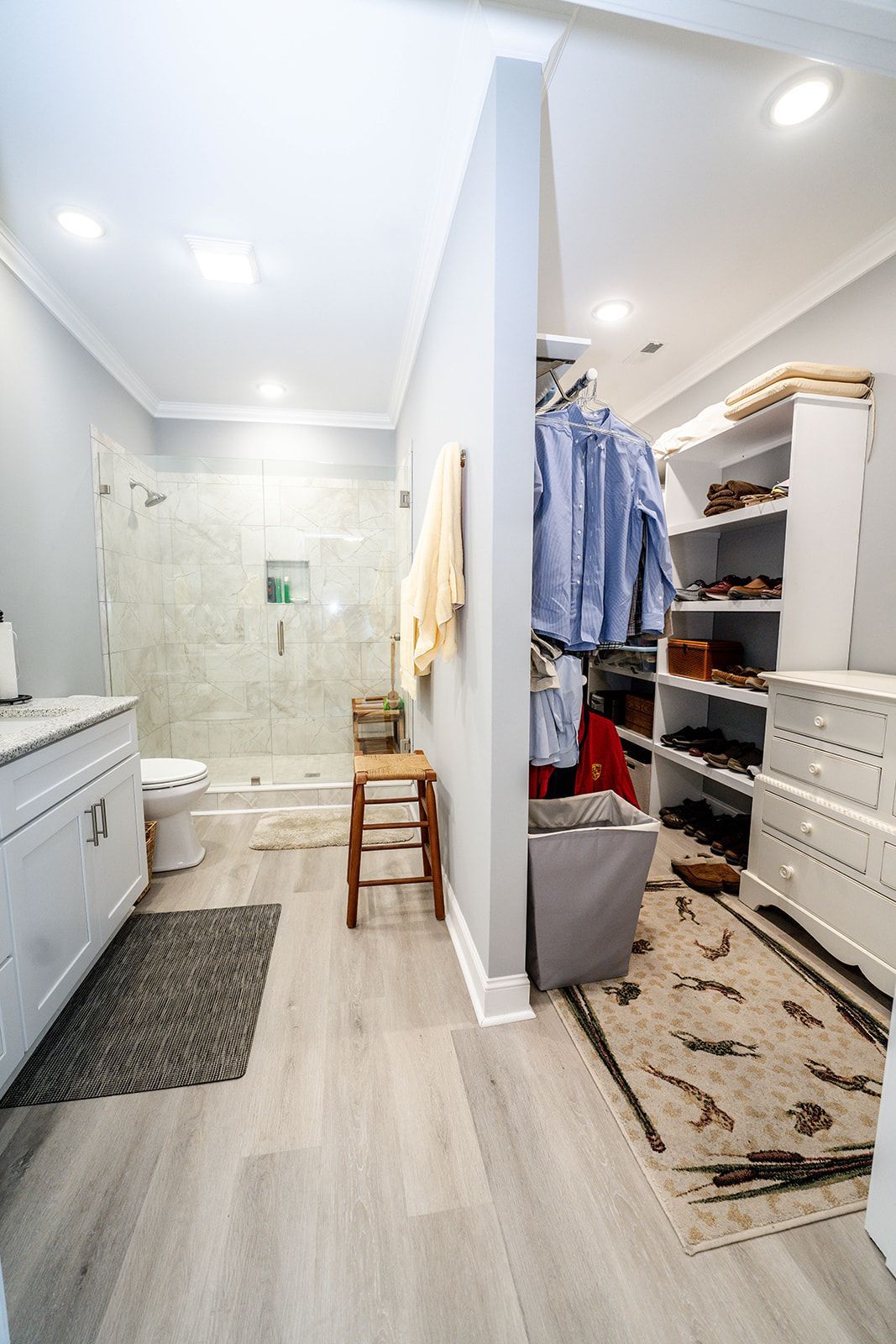 A bathroom with a walk in closet and a toilet.
