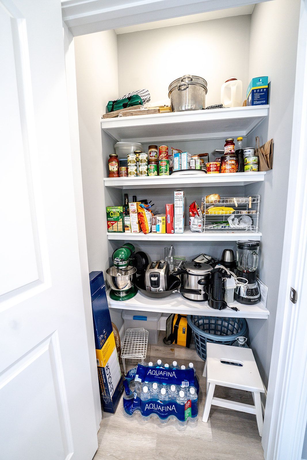 A pantry filled with lots of food and appliances.