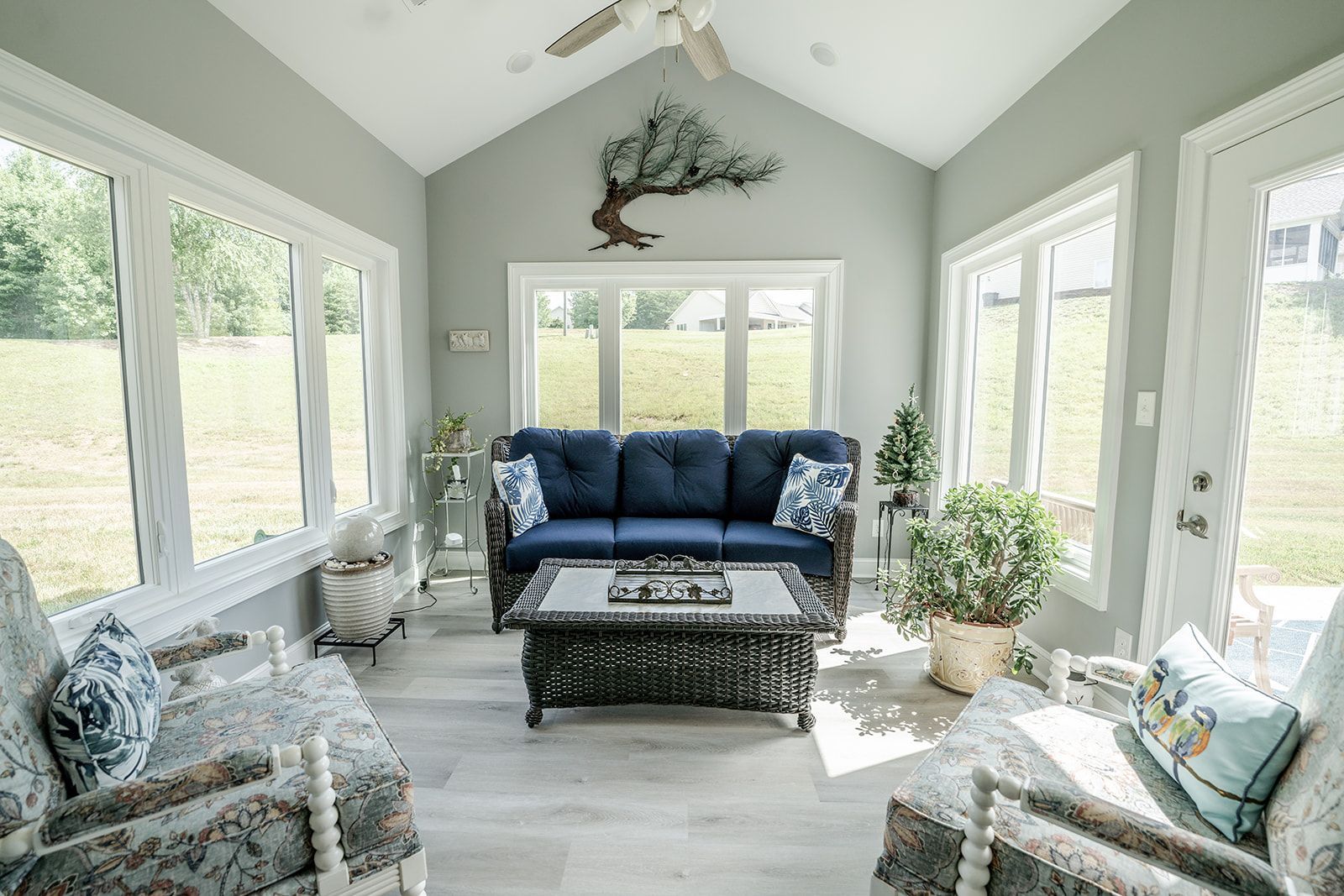 A living room with a couch , chairs , and a table.