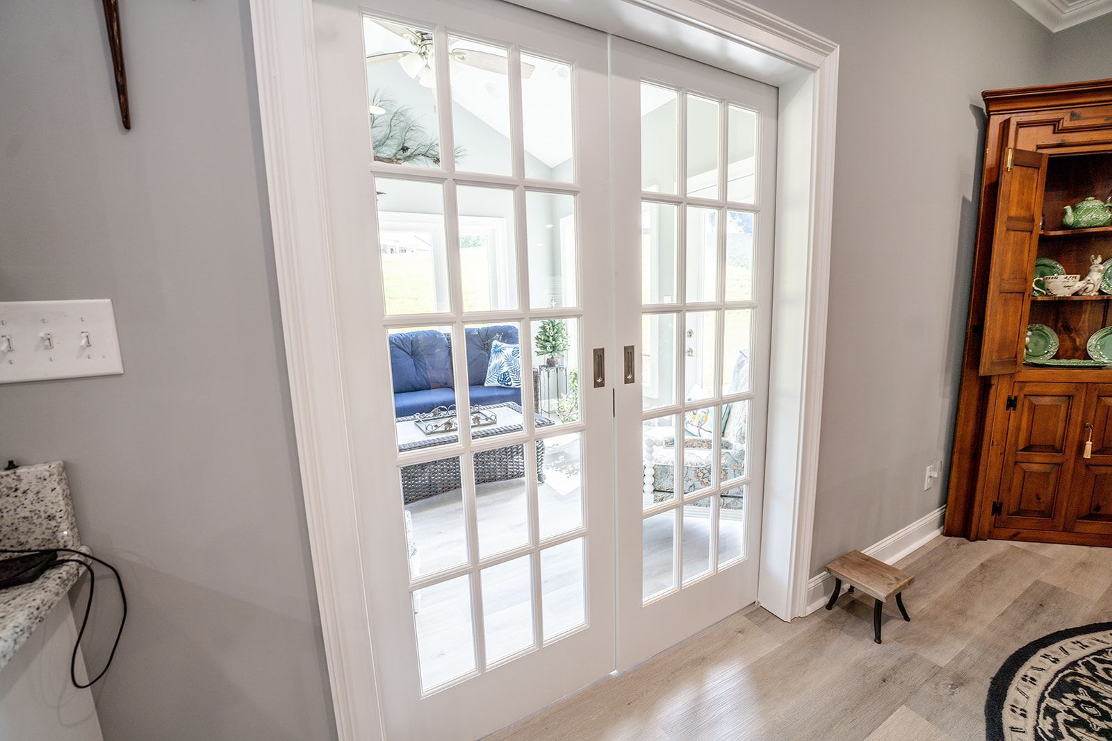 A room with french doors leading to a patio.