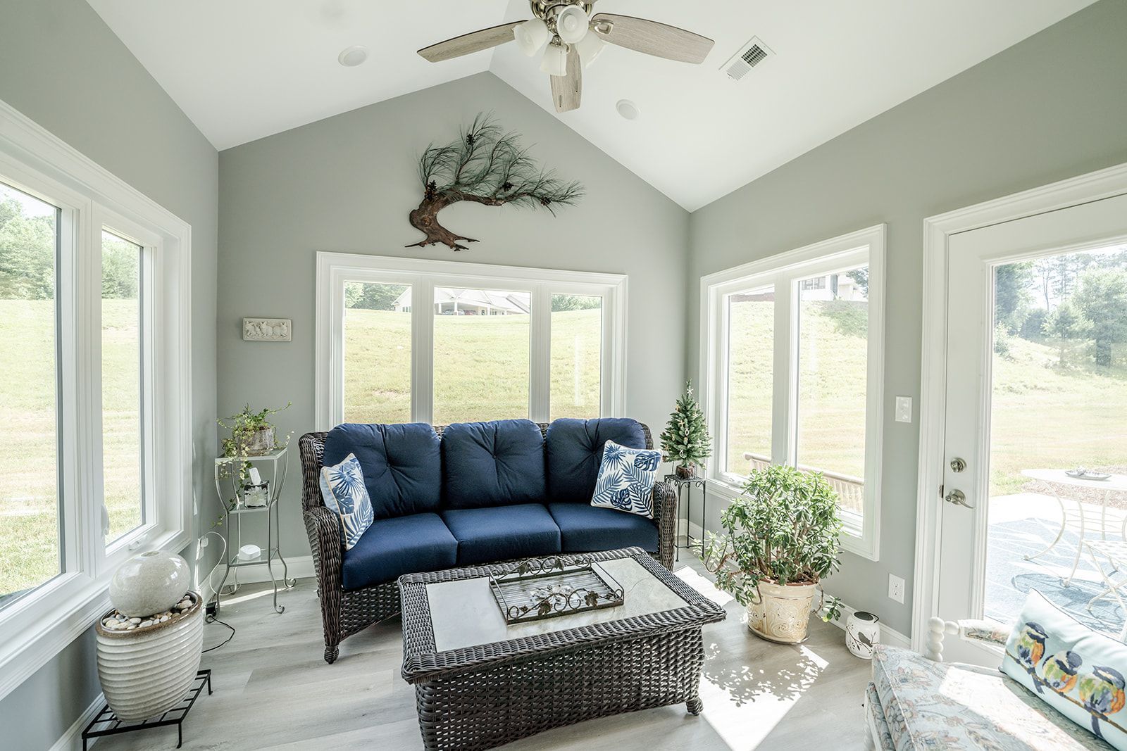 A living room with a couch , coffee table , and ceiling fan.