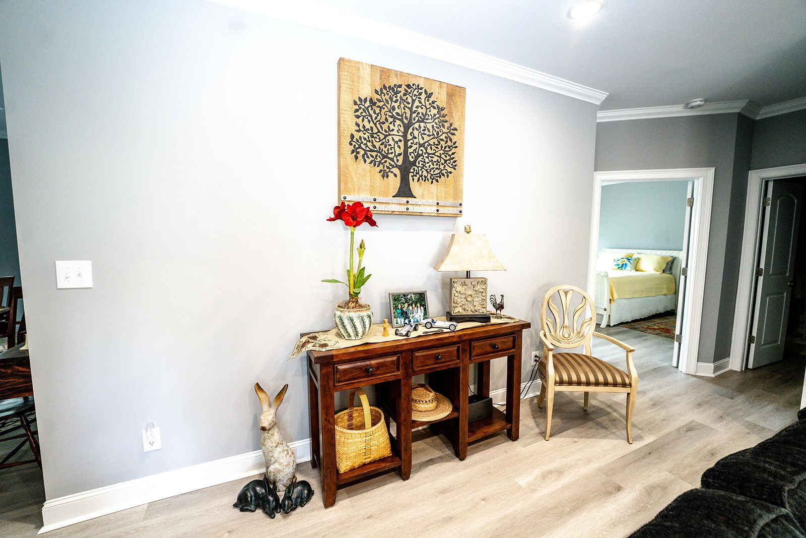 A living room with a table and chairs and a painting on the wall.