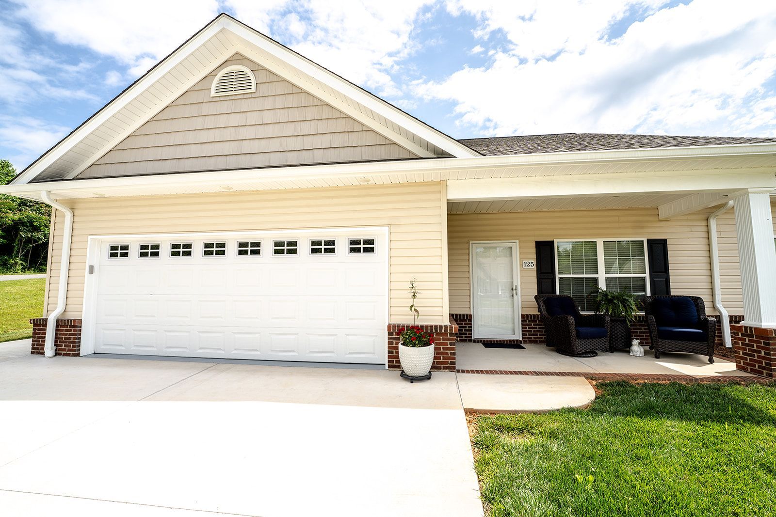 A house with a white garage door and a porch.
