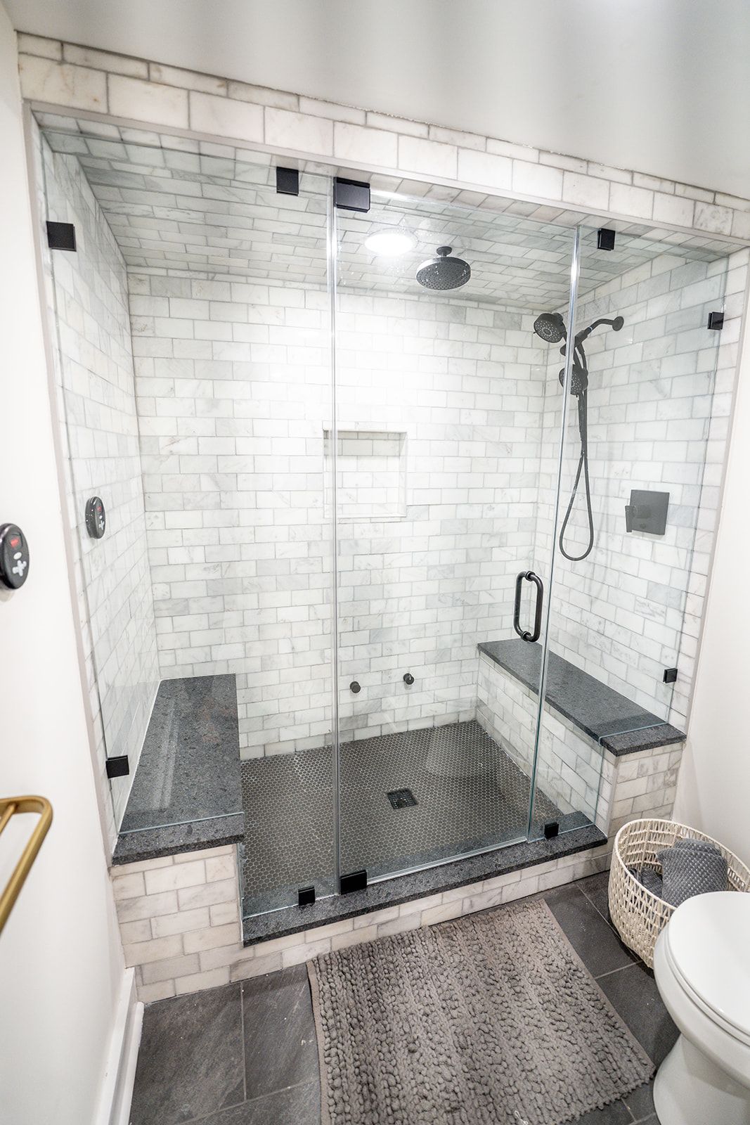 A bathroom with a walk in shower and a toilet.