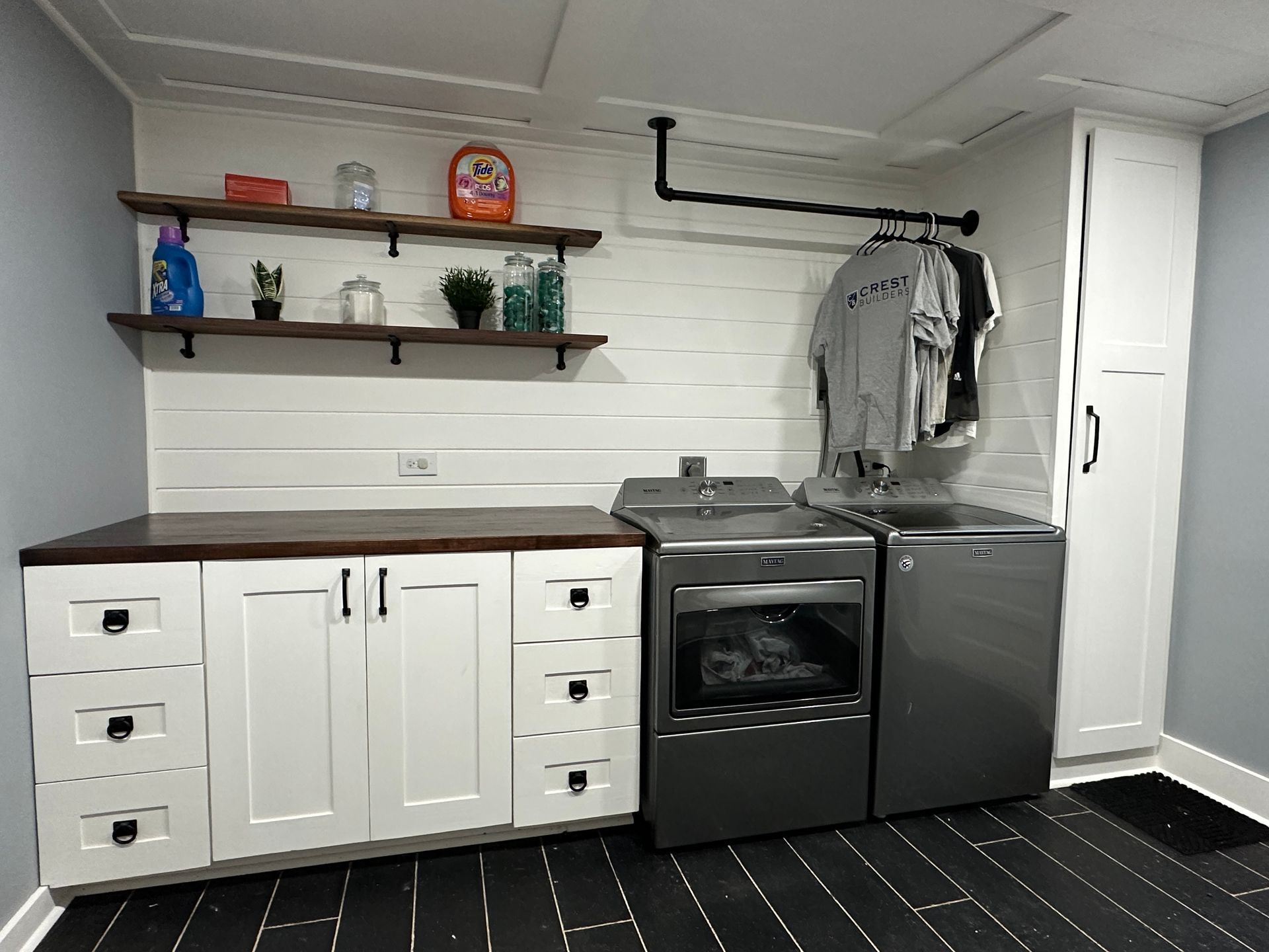 A laundry room with a washer and dryer and a sink.