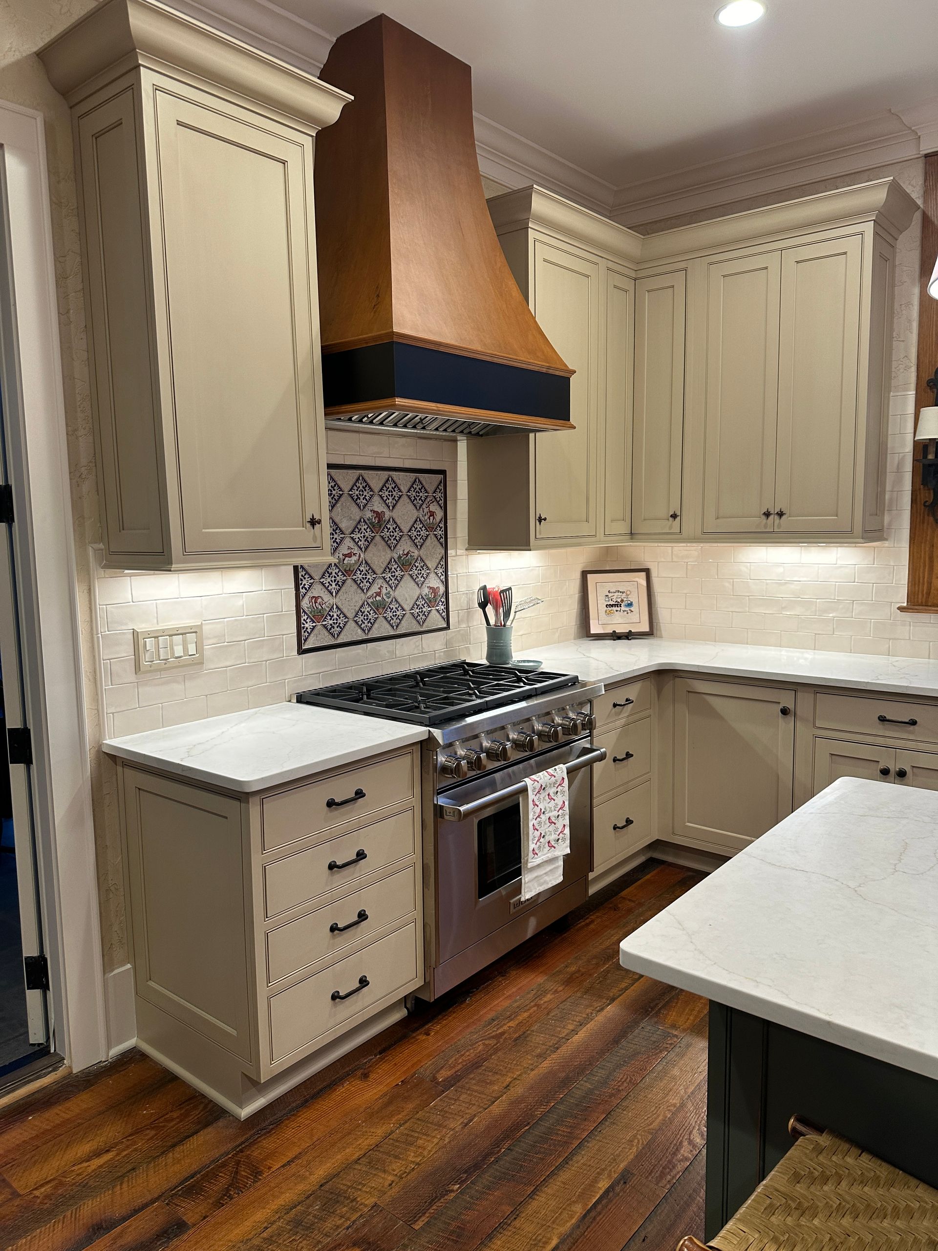 A kitchen with stainless steel appliances and white cabinets