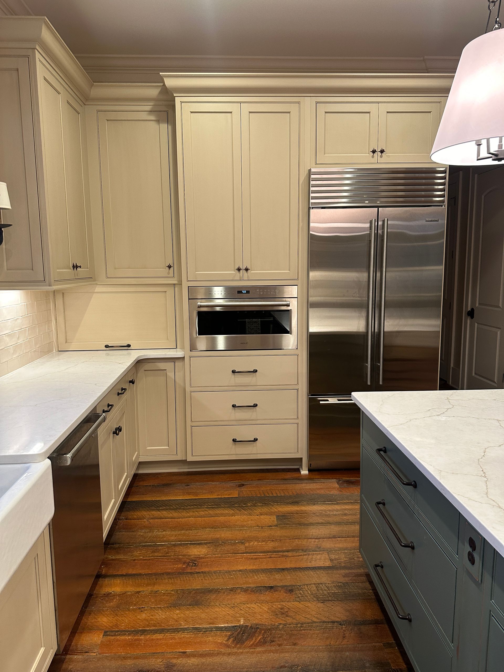 A kitchen with white cabinets and stainless steel appliances
