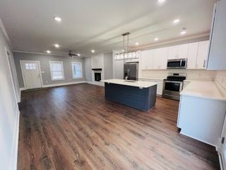 A kitchen with a large island in the middle of the room.