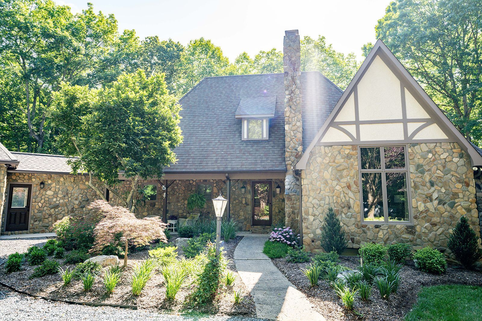 A large stone house with a walkway leading to it