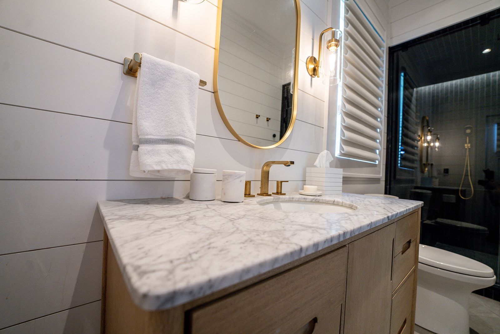 A bathroom with a sink , mirror and toilet.