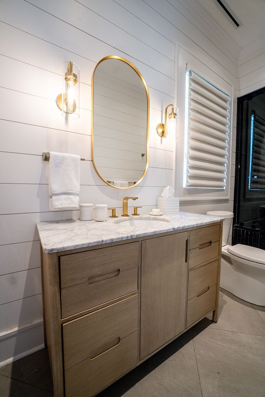 A bathroom with a sink , mirror , and cabinets.