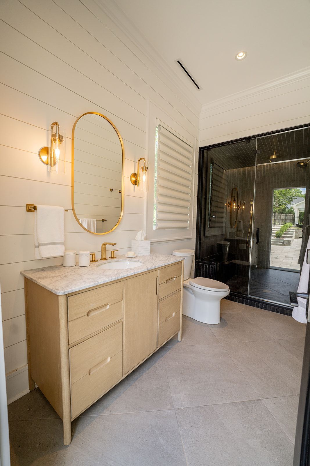 A bathroom with a sink , toilet and mirror.