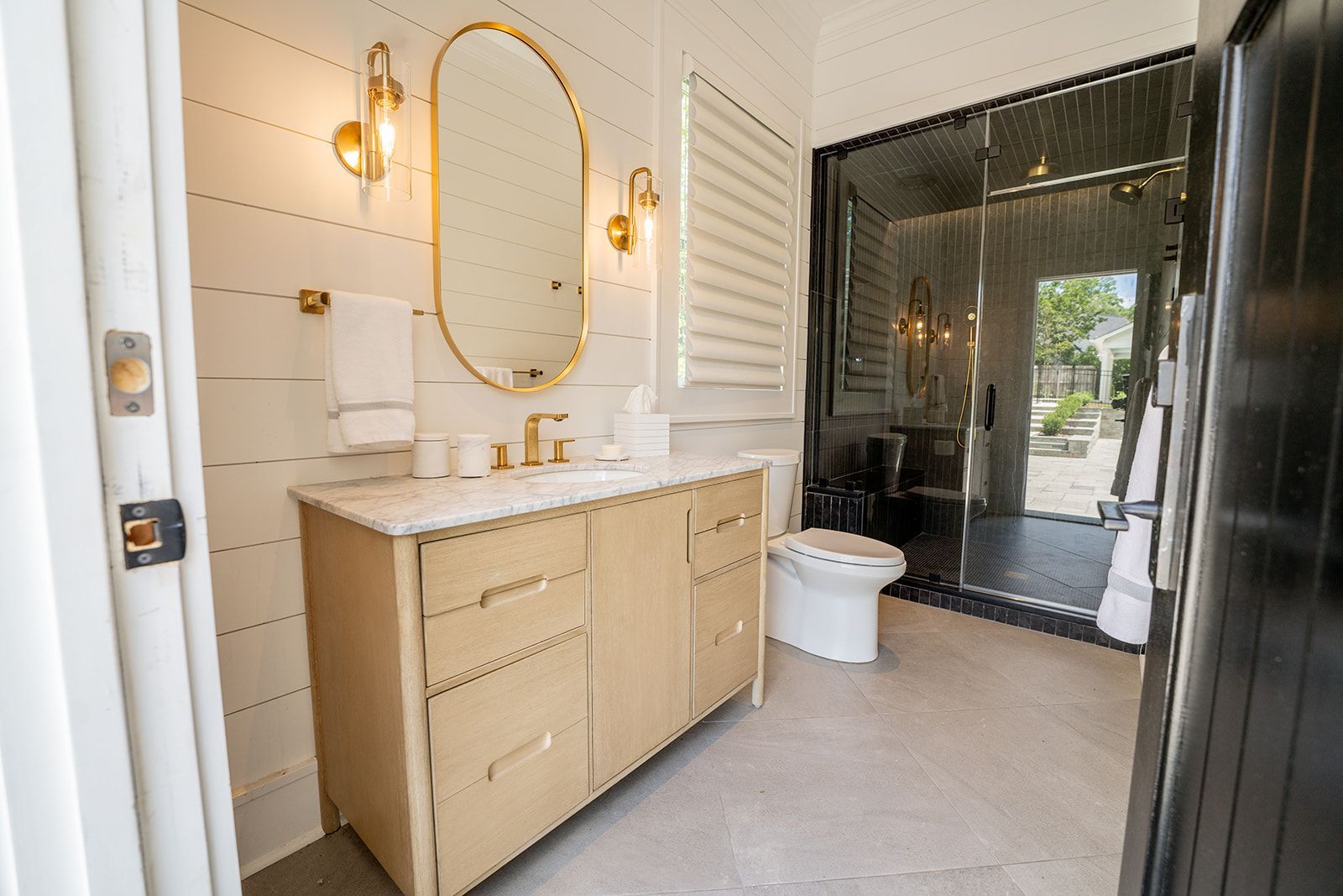 A bathroom with a sink , toilet and mirror.