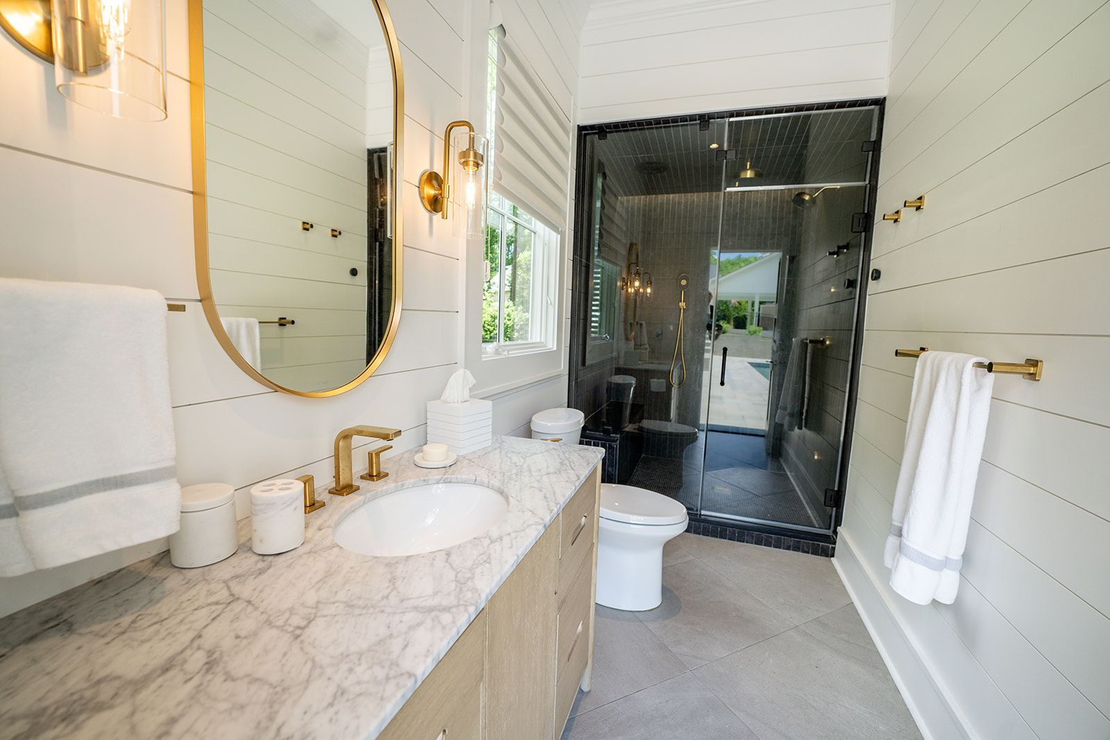 A bathroom with a sink , toilet , and mirror.