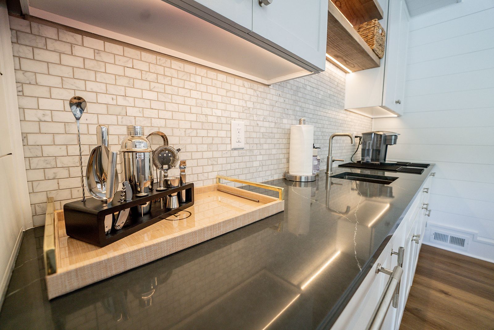 A kitchen counter with a tray of utensils on it.