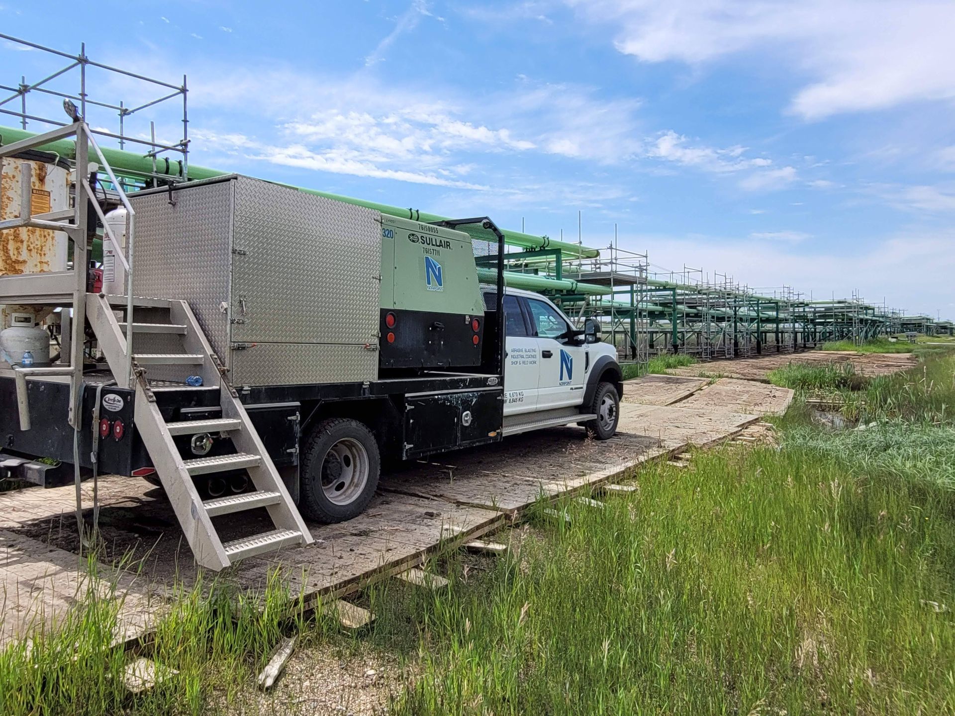 Norpoint service vehicle at a pipeline site where coating application is underway
