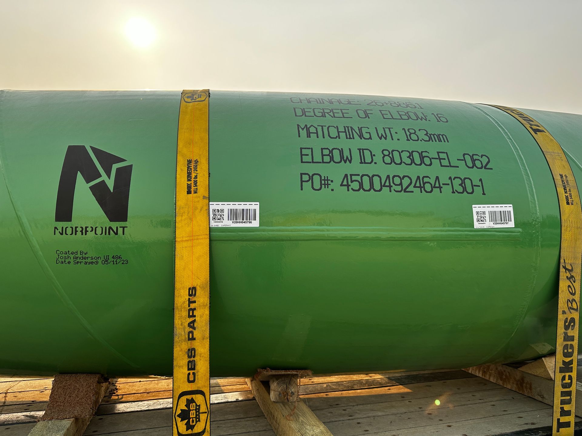 Close-up of labeled pipe after blast cleaning and final protective coating at Norpoint