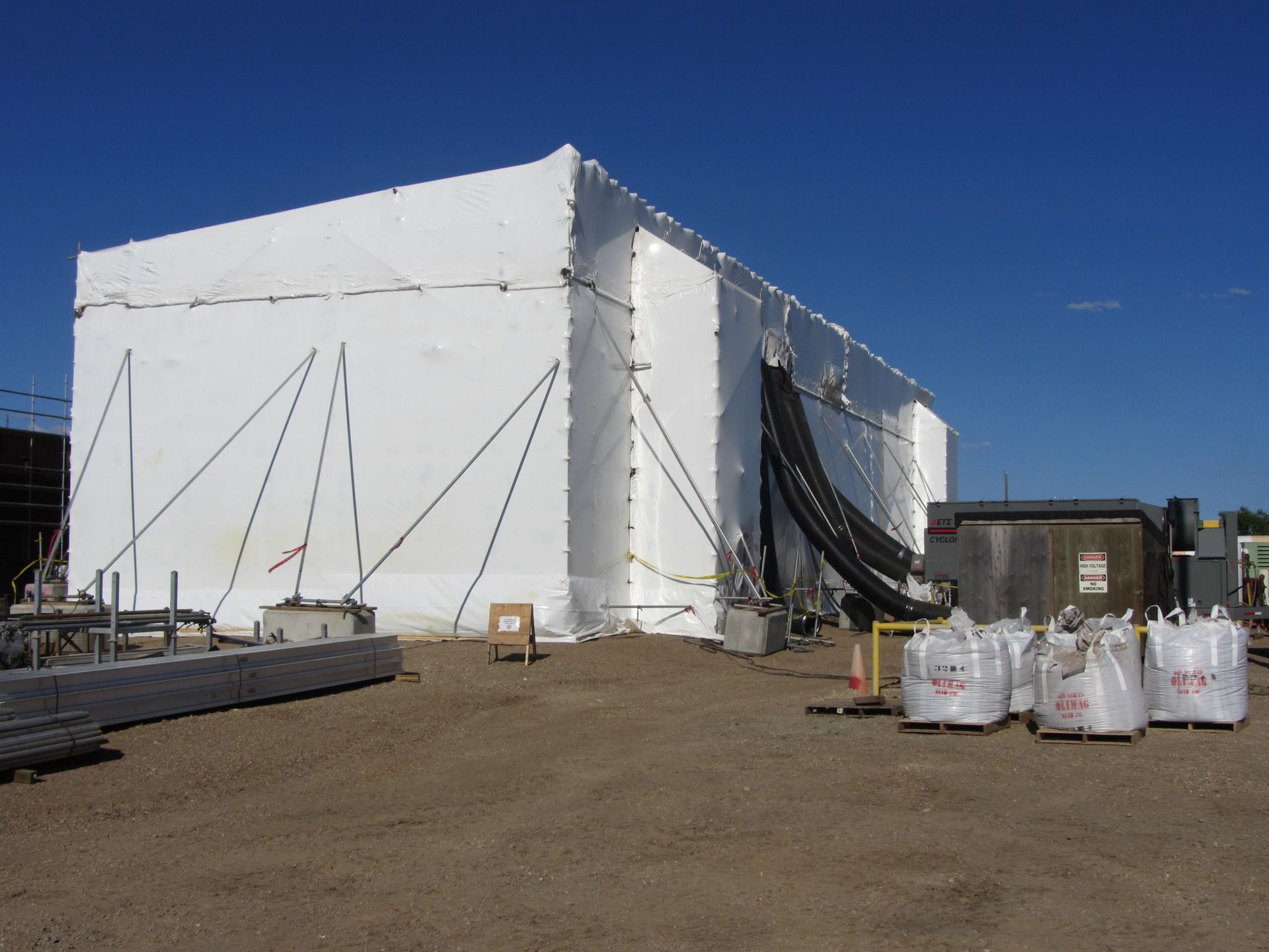 Temporary enclosure structure used for controlled coating environment on a pipeline project site