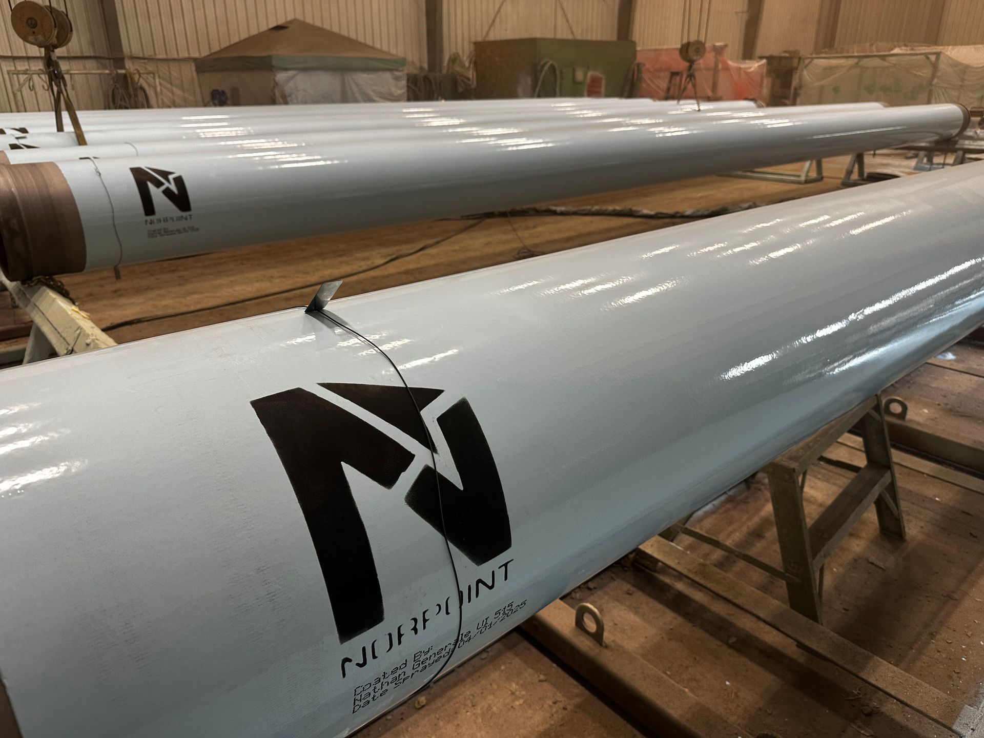High-quality blast cleaning and coating showcasing Norpoint branding on pipeline