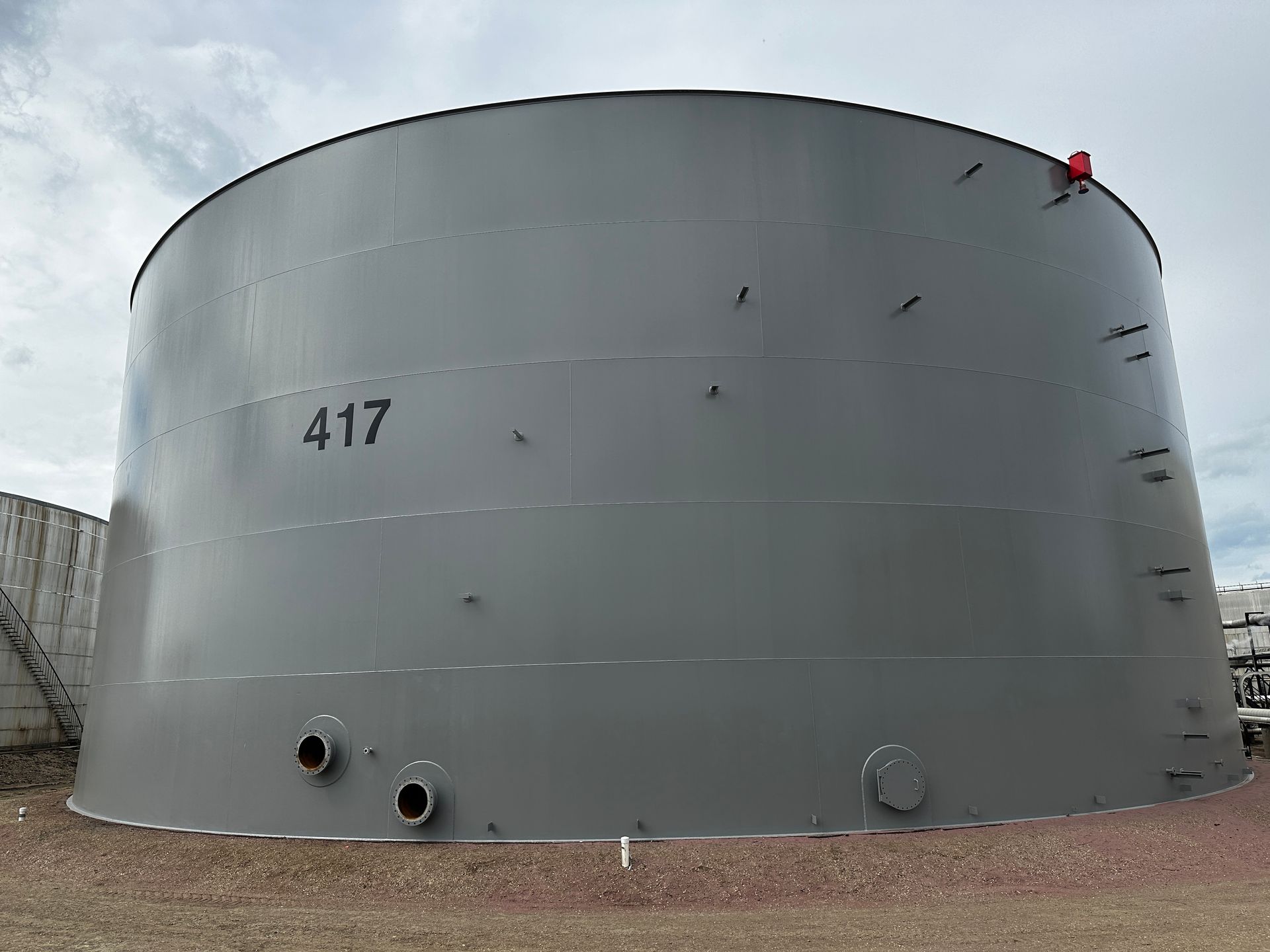 Industrial tank prepped for tank painting, showing bare metal surface ready for coating application