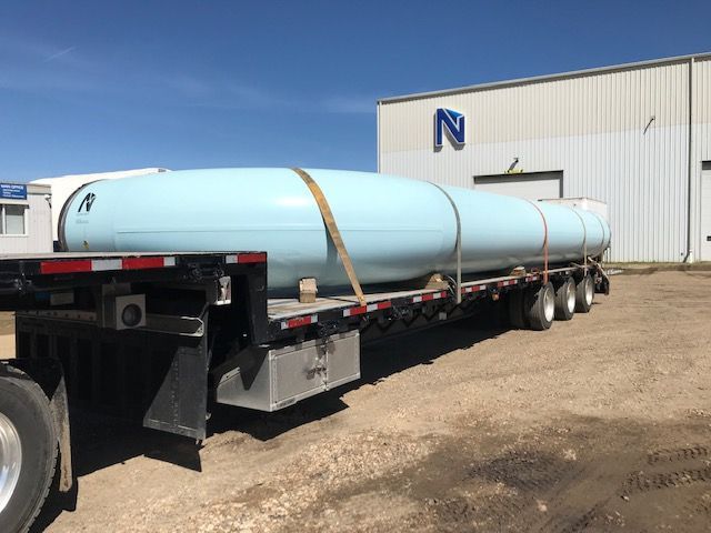 Freshly blast-cleaned and coated pipe loaded on trailer outside Norpoint facility