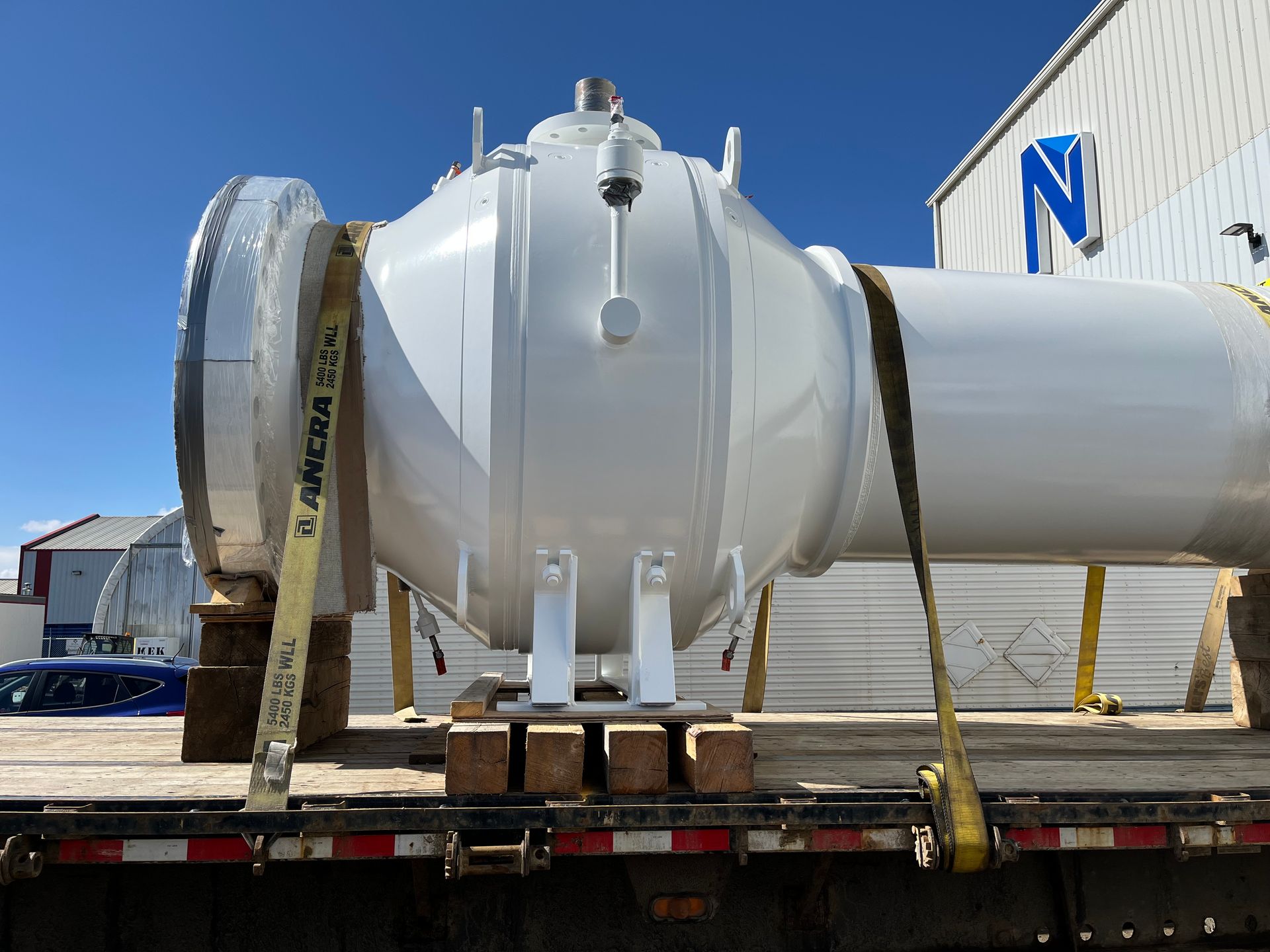 White-coated industrial tank post-blast cleaning, secured and ready for delivery