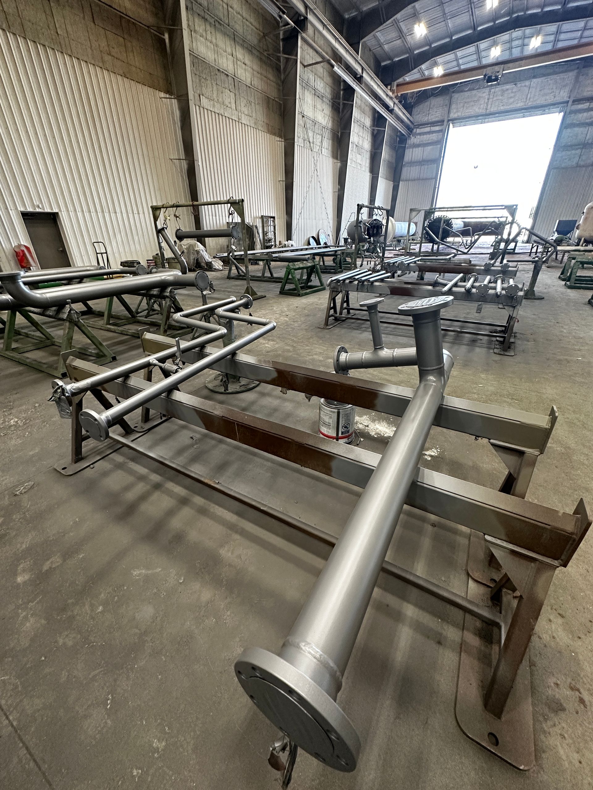 Industrial piping frames arranged in Norpoint’s shop, post-blast cleaning and surface preparation