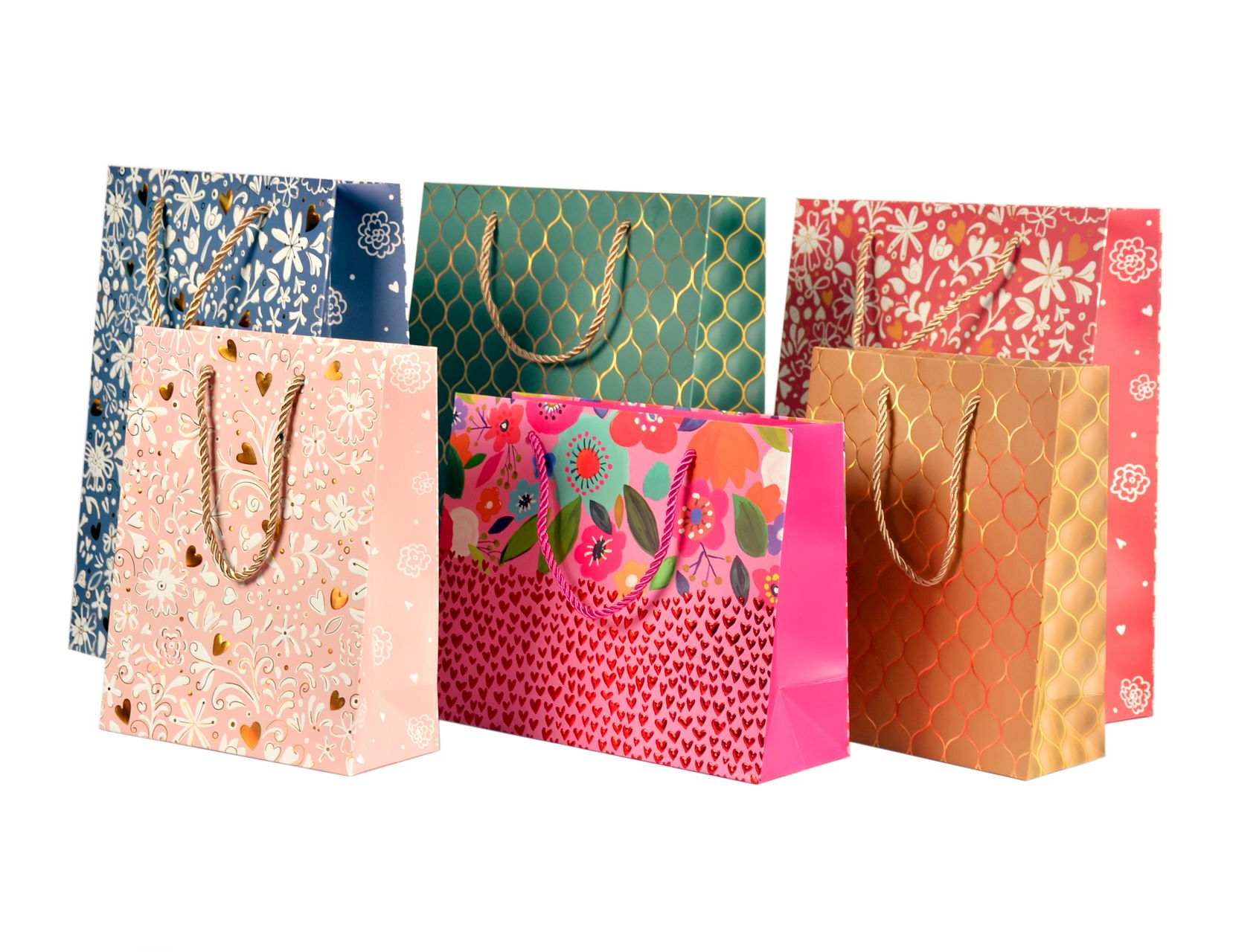 Gift bags with various floral patterns and gold handles.