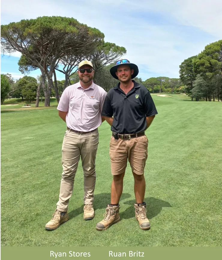 two men are standing next to each other on a golf course .